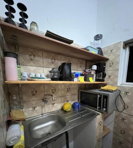 a kitchen with a sink and a microwave at Bel appartement avec petit balcon sympa in Porto-Novo