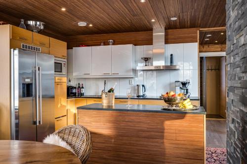 a kitchen with white cabinets and a counter top at The Little Elk in Ruka