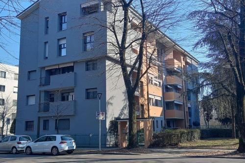 two cars parked in front of a blue building at Spilamberto 6b in San Donato Milanese