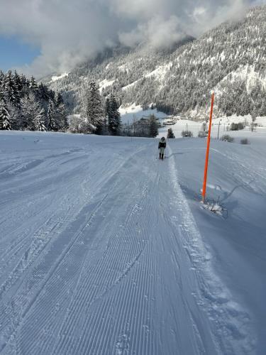 a person is skiing down a snow covered slope at Basislager Fieberbrunn in Fieberbrunn