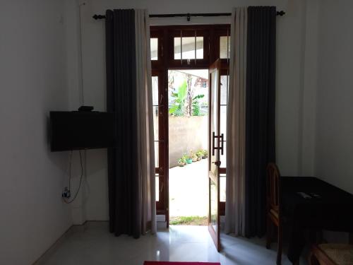 an open door to a room with a glass at Star Guest in Balangoda