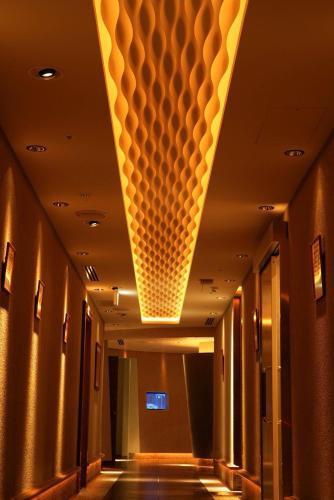 a hallway with a lighted ceiling in a building at THE skM TOKYO HOTEL & DINING in Tokyo