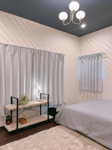 a bedroom with a bed and a table and a window at Alo BnB 2 - Near NIPPORI, YANAKA GINZA, UENO, SENSOJI - Self check-in in Tokyo