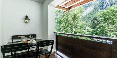 a balcony with a table and a large window at Hotel Zur Schanz in Ebbs