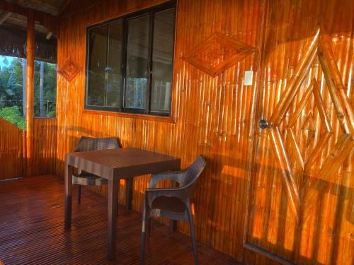 a wooden room with a table and two chairs at Virly’z Top View Resort in Tudela
