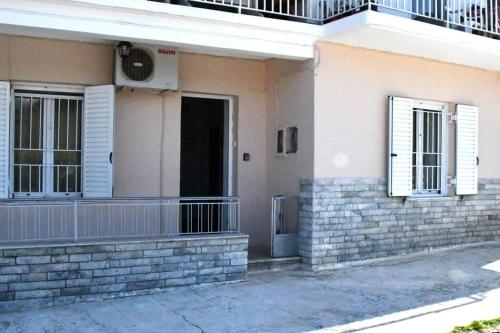 a building with white windows and a balcony at Sitos Home in Sparti