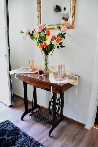 a table with a vase of flowers on it at Sitos Home in Sparti