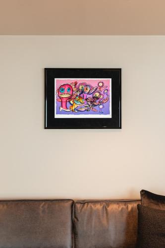 a picture hanging on a wall above a couch at Odda View in Odda