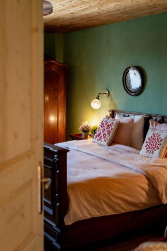a bedroom with a large bed with a green wall at Bodensee Apartments, Sauna, Lake Walks, Free Parking, Self Checkin, Nature Reserve, Restaurants Nearby in Gaißau