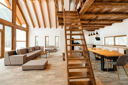 a living room with a wooden ladder and a table at Scrind 11 - Madleine Chalet in Cluj-Napoca