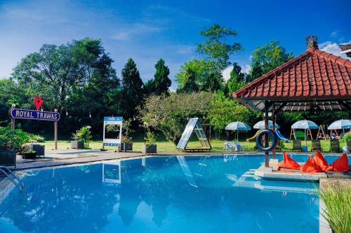 a swimming pool at a resort with a gazebo at Royal Trawas Hotel & Cottages in Trawas