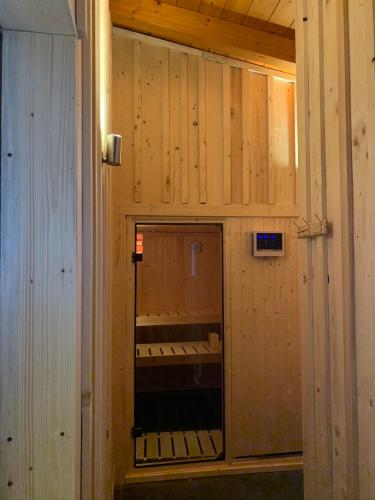 a room with wood paneled walls and a mirror at Sonnenchalet mit Sauna in Kötschach