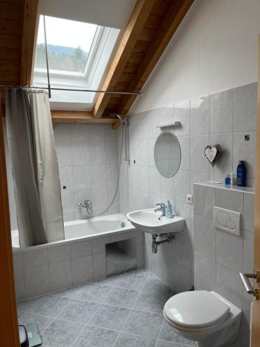 a bathroom with a toilet and a sink and a tub at Sonnenchalet mit Sauna in Kötschach