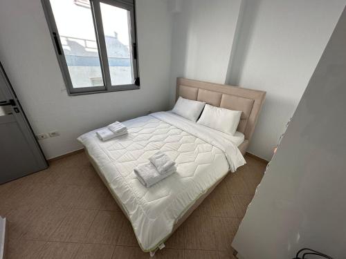 1 dormitorio con 1 cama con 2 toallas en Taulant, en Sarandë