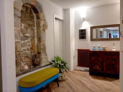 a living room with a bench and a stone wall at Il Nido delle Rondini in Levanto