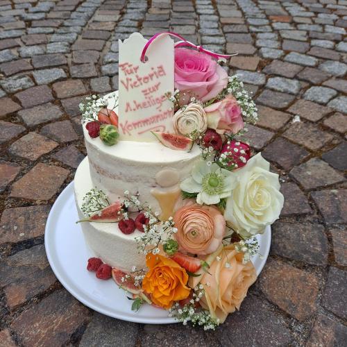 a birthday cake on a plate with flowers on it at Kloster Bonlanden in Berkheim