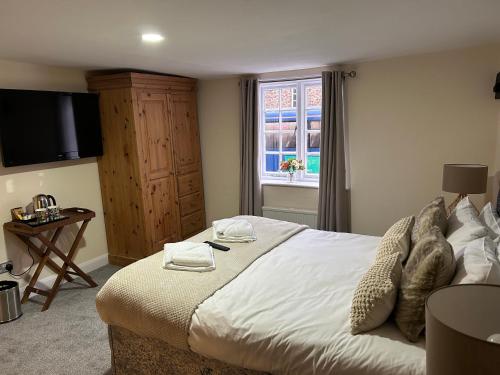 a bedroom with a large bed and a window at Bay Horse in York