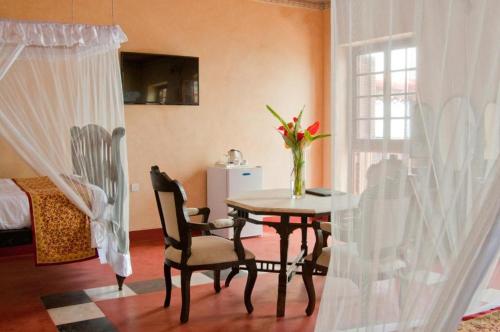 a room with a table and chairs and a window at Mizingani Seafront Hotel in Zanzibar City