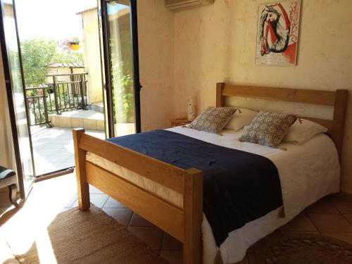 a bedroom with a bed with a blue comforter at Magnifique villa piscine Propriano in Olmeto