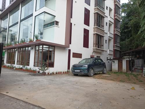 a car parked in front of a building at Golden Peaks Hotel & Restaurant in Kalimpong