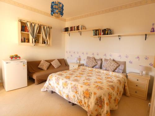 a bedroom with a bed and a couch at Villa Magnolia B&B in Taormina