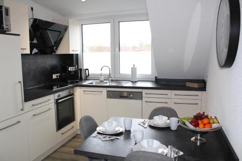 a kitchen with a table with a bowl of fruit on it at Ferienwohnungen Zur Abtei Bodenseeregion in Ravensburg