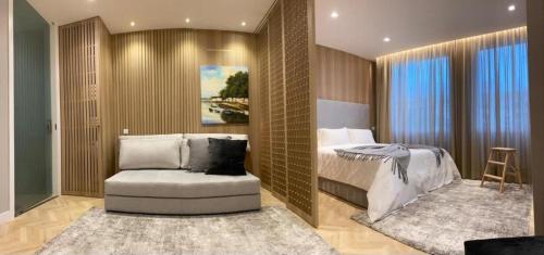 a bedroom with a bed and a chair in it at Alamedastudio in Vila do Conde