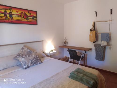 a bedroom with a bed and a table and a desk at Habitación privada en casa particular, montaña in Olesa de Bonesvalls