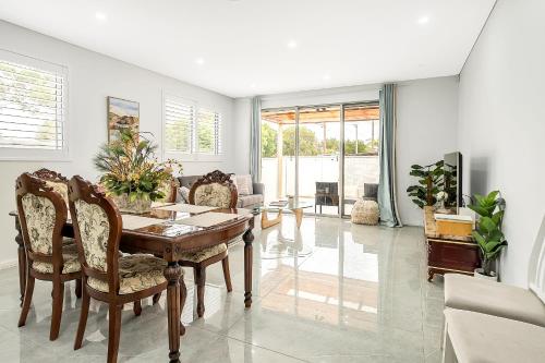 a dining room with a table and chairs at Blue Haven Retreat - Beverly Hills 208 in Sydney