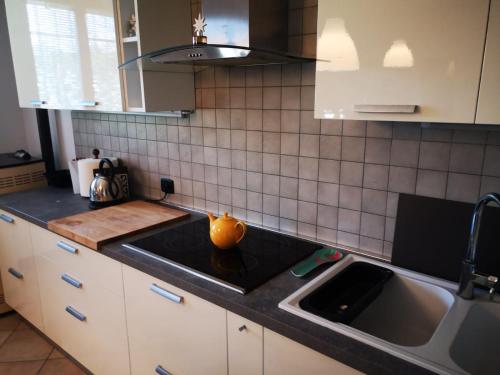 a kitchen with a sink and a stove top oven at SUITE TRAVEL HOME in Modena