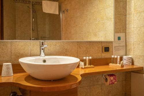 a bathroom with a white bowl sink on a counter at Relais Isole del Sud in Lampedusa
