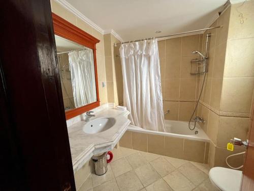 a bathroom with a sink and a bath tub at Nabq Bay Amwaj Oyoun Hotel in Sharm El Sheikh