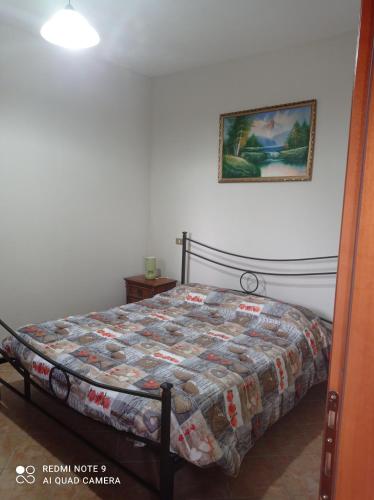 a bedroom with a bed with a quilt on it at Lovely 1-Bed Apartment in Gallinaro in Gallinaro
