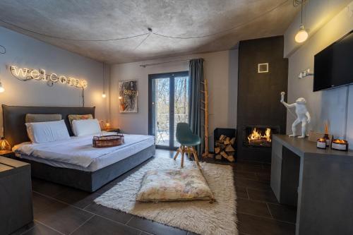 a bedroom with a bed and a fireplace in it at Oniropetra Boutique Hotel in Karpenision