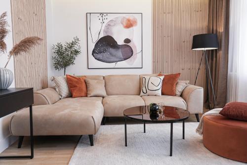 a living room with a couch and a table at ZEST Residence in Kragujevac