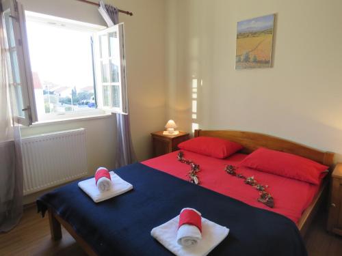 a bedroom with a bed with santa hats on it at Apartments JoDi pool Novalja in Novalja