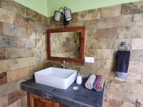 a bathroom with a sink and a mirror at Mandaram villas in Mararikulam