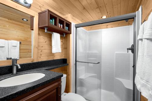 a bathroom with a shower and a sink at Sun Outdoors North Moab in Moab