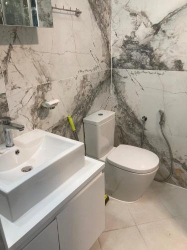 a bathroom with a white sink and a toilet at Studio "Victoria" in Burgas City