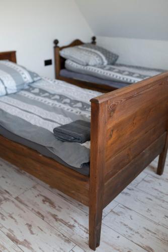 a wooden bed with a wooden frame in a bedroom at Mieciówka in Lasowka