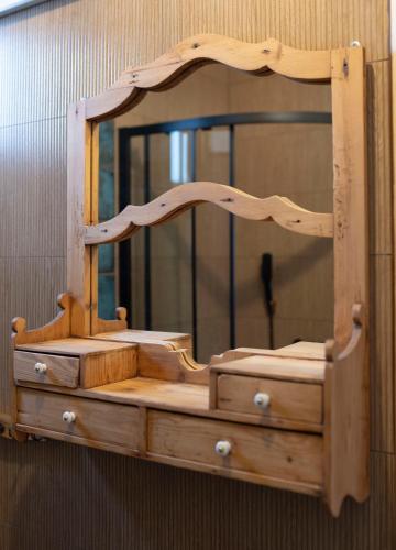 a wooden dresser with a mirror on a wall at Mieciówka in Lasowka