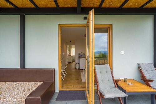 a room with a bed and a table and a mirror at AKORD chata in Námestovo