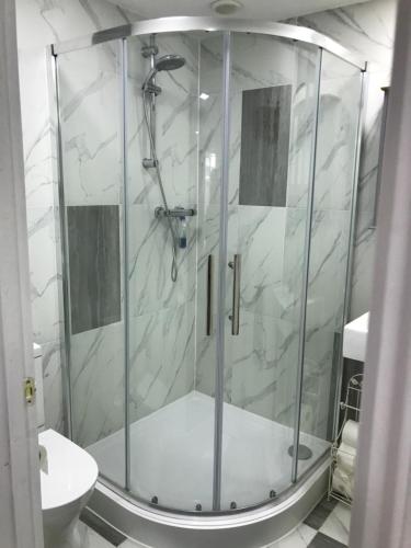 a shower with a glass door in a bathroom at Annexe in lymington with private use of hot tub in Everton