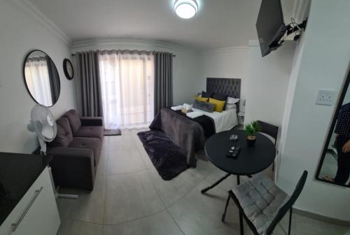 a living room with a couch and a table at Marielitsa Guest Suite No 3 in Germiston