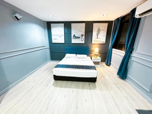 a bedroom with a bed and blue walls at 61 Hotel in Gua Musang