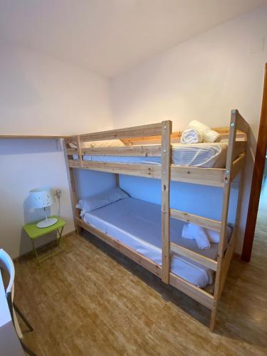 two bunk beds in a room with a table at Casa Mario & Amaya in Riumar