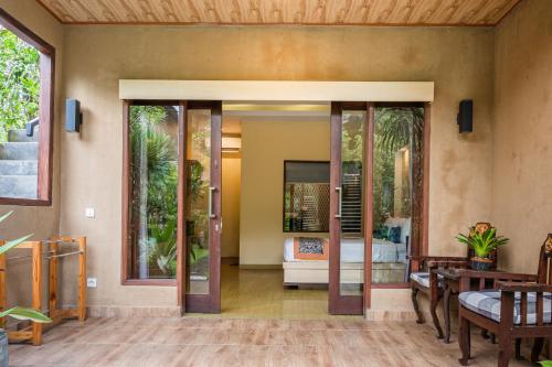 an open living room with sliding glass doors at Dewangga Ubud in Ubud