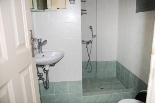 a bathroom with a sink and a shower at M. Houses 3 in Agios Romanos