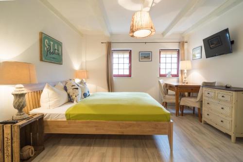 a bedroom with a bed and a desk and a table at Villa Bellevue 3 _App_ 12 in Ahlbeck