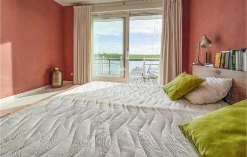 a large bed in a room with a window at Stunning Home In Workum With Kitchen in Workum
